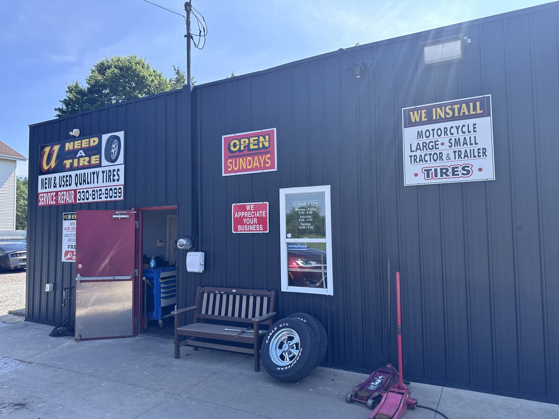 Front entrance of U Need A Tire on Massillon Road in Akron, Ohio, with Open Sundays sign