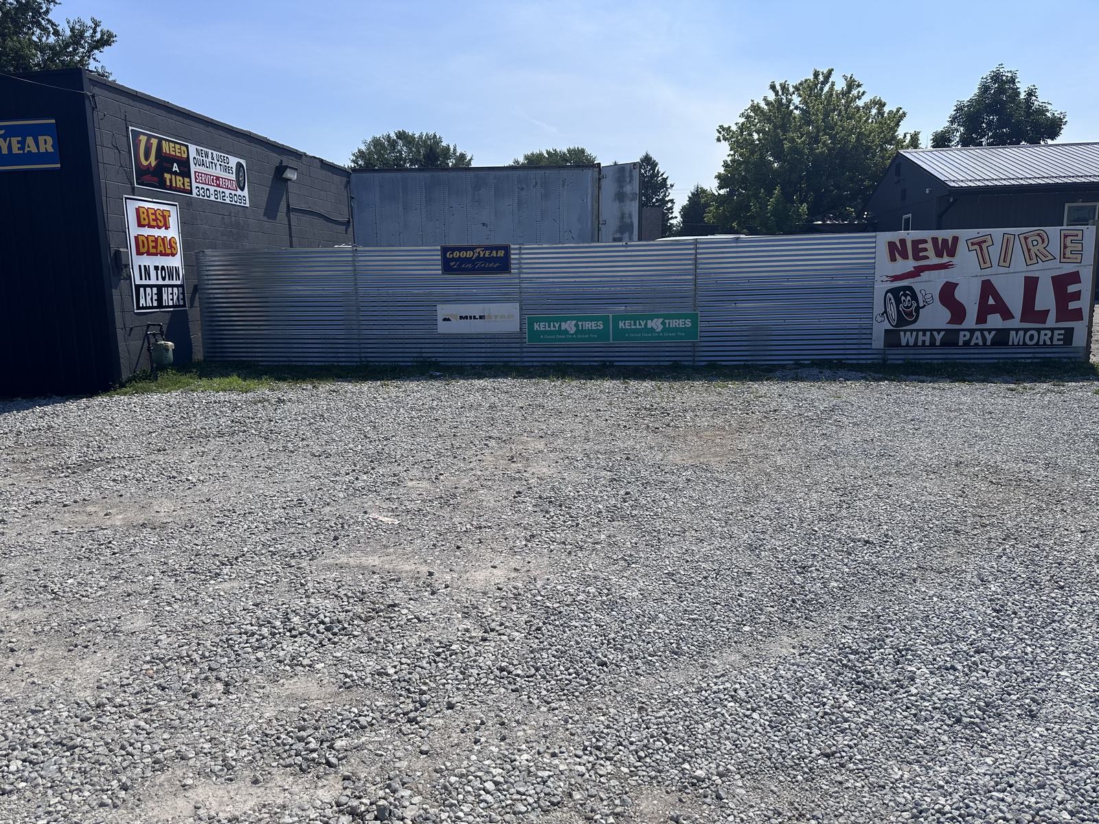 U Need A Tire lot in Akron with Goodyear, Kelly Tires and Milestar signs and new tire sale banner